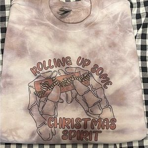 Rolling up Christmas Spirits crewneck